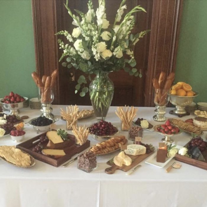 Table of cheese, crackers, bread and fruit